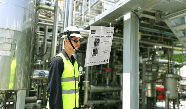Industrial worker using smart glasses with a floating operations display